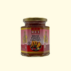 MDS Bread Pakroa Chutney is carefully crafted with traditional Indian spices, giving it a distinct, authentic flavor. This 350g chutney pairs perfectly with savory dishes or can be used to add a bit of zest to sandwiches and wraps. Enjoy the robust flavor of this classic condiment and tantalize your taste buds.